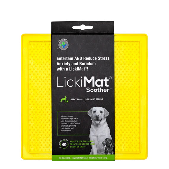 LickiMat Pastel Soother Yellow with dog licking