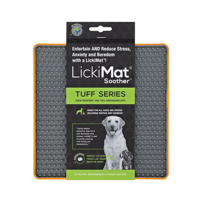 LickiMat Soother Tuff Orange with dog licking